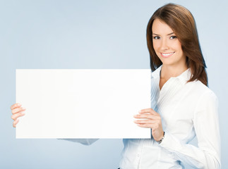 Businesswoman showing signboard, over blue