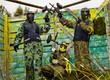 Paintball players in full gear at the shooting range