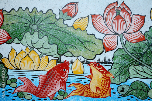 Naklejka na szybę Fishes of Wealth and Lotus painting on stone wall.