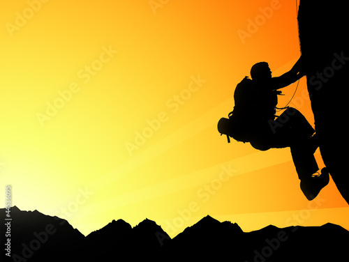 Fototapeta na wymiar Silhouette of climbing young adult at the top of summit