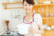© one - Beautiful young woman in the kitchen. Portrait of asian.
