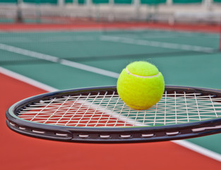 Tennis court with ball and racket