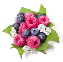 Wall Mural - Ripe raspberry and blueberries with green leaf