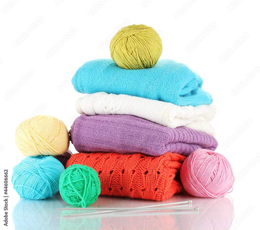 Sweaters and balls of wool isolated on white