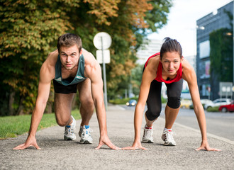 Wall Mural - Rivalry - young couple competing in running