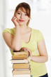 © Piotr Marcinski - Young caucasian woman with books