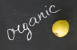 Fresh pear on  blackboard and word organic written by white chal