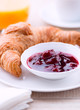 Cherry marmalade and croissant on a plate