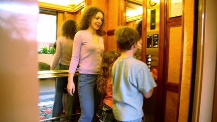 Wall Mural - Mother with kids walk in elevator, then doors closes