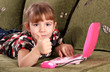 little girl with thumb up and laptop