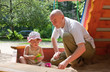 © DariaTrofimova - father with  toddler playing  in sandbox