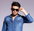 © Viorel Sima - man holding his fashionable sunglasses