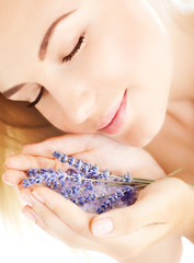 Beautiful girl smell lavender flowers