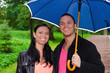 © M-Production - Portrait of young couple under umbrella in the park