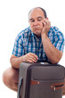 Bored traveller man with luggage