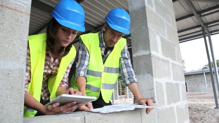 Wall Mural - Construction team working on project with tablet