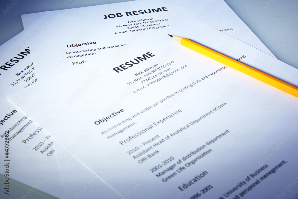 Closeup of resume with pencil on blue background