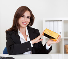 Businesswoman Holding Gold Bar