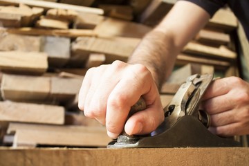 carpenter working  with old plane