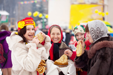 Wall Mural - Women  eating pancakes during  Shrovetide