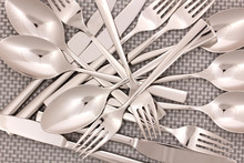 Forks, Knifes And Spoons On Grey Mat Close-up