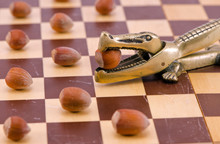 Gold Crocodile Nut Crush Tool On Chess Board