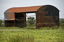 Rusty Barn In Field