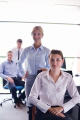 Wall Mural - business woman with her staff in background at office