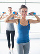 © WavebreakmediaMicro - Smiling woman lifting weights