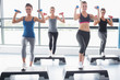 © WavebreakmediaMicro - Four women lifting weights while doing aerobics