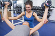 © WavebreakmediaMicro - Trainer teaching woman lifting weights