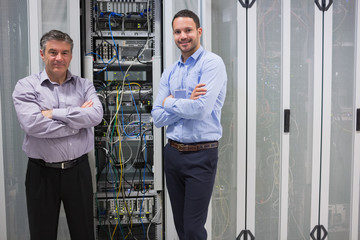 Poster - Two smiling men standing in front of servers