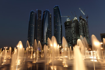 Fototapete - Skyscrapers in Abu Dhabi at dusk, United Arab Emirates