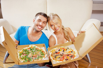 Wall Mural - romantic couple eating pizza at home