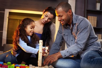 Happy family playing together at home