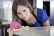 © AntonioDiaz - Cute young woman cleaning a counter top