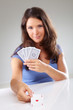 Woman with playing cards,  focus on ace of hearts