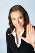 © vgstudio - Businesswoman with stop gesture, over blue