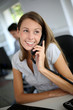 © goodluz - Beautiful office worker talking on the phone