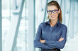 © ZoomTeam - business woman holding glasses and looking at camera. Copy space