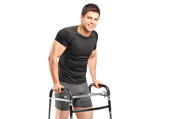 A young smiling athlete using a walker