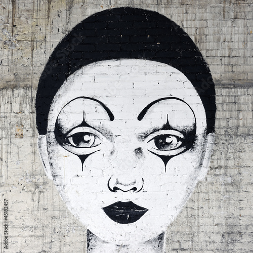 Obrazy Banksy  biale-graffiti-klauna-na-ceglanym-murze