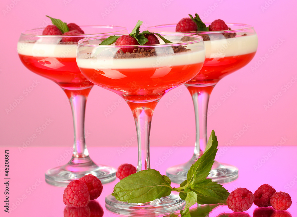 fruit jelly with berries in glasses on pink background