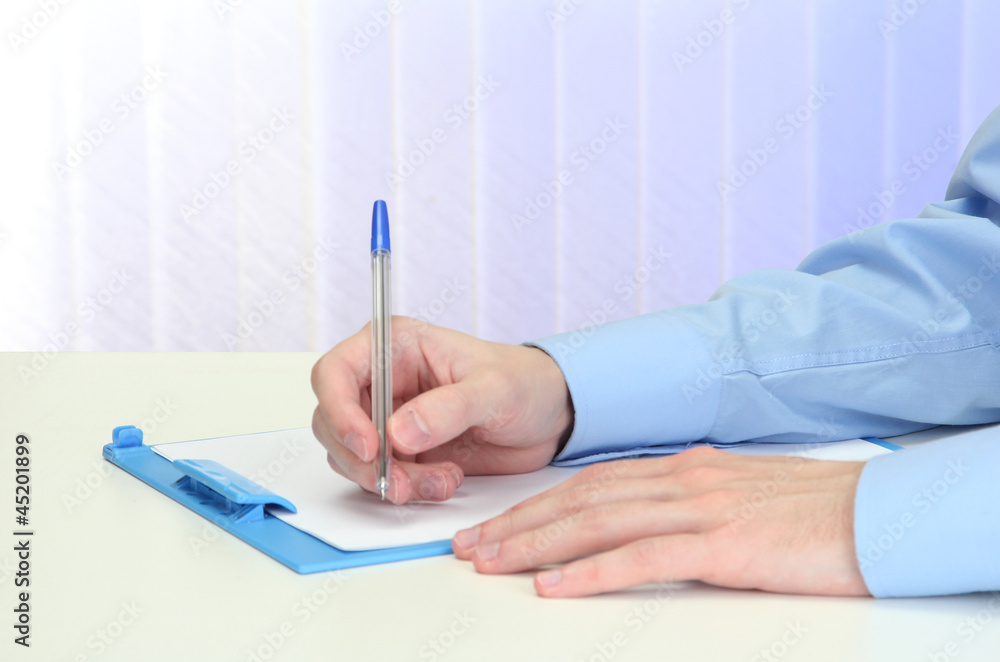 Closeup of businessman hands with clipboard