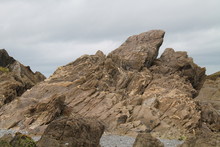 A Dramatic Rocky Outcrop On A Coastal Beach.