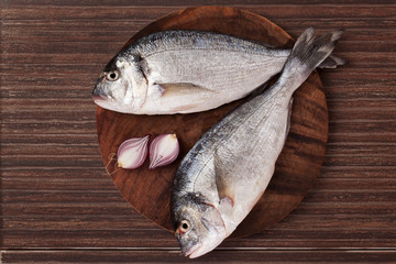 Wall Mural - Fish on wooden chopping board.