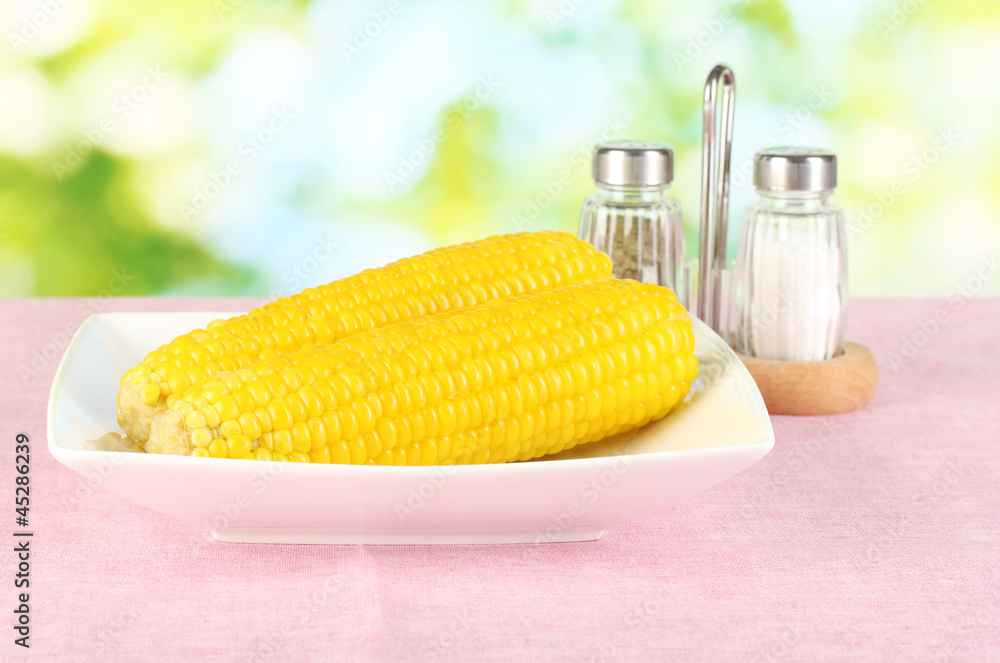 boiled corn on the pink table cloths on the background of