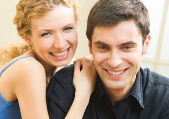 Canvas Print - Cheerful smiling young couple, indoors