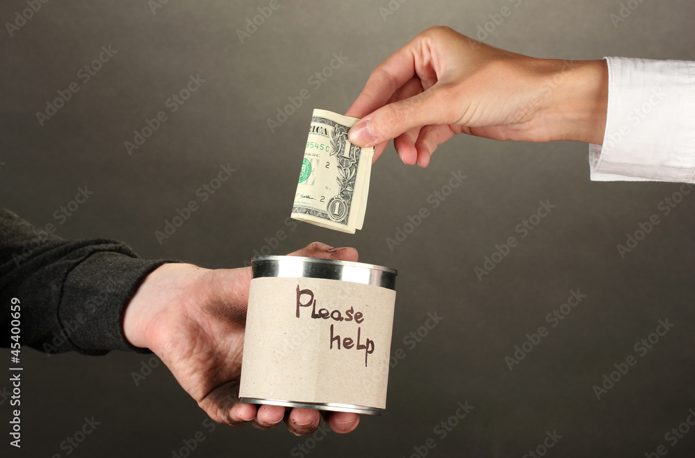 helping the homeless, on black background close-up