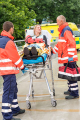 Wall Mural - Injured woman talking with paramedics emergency